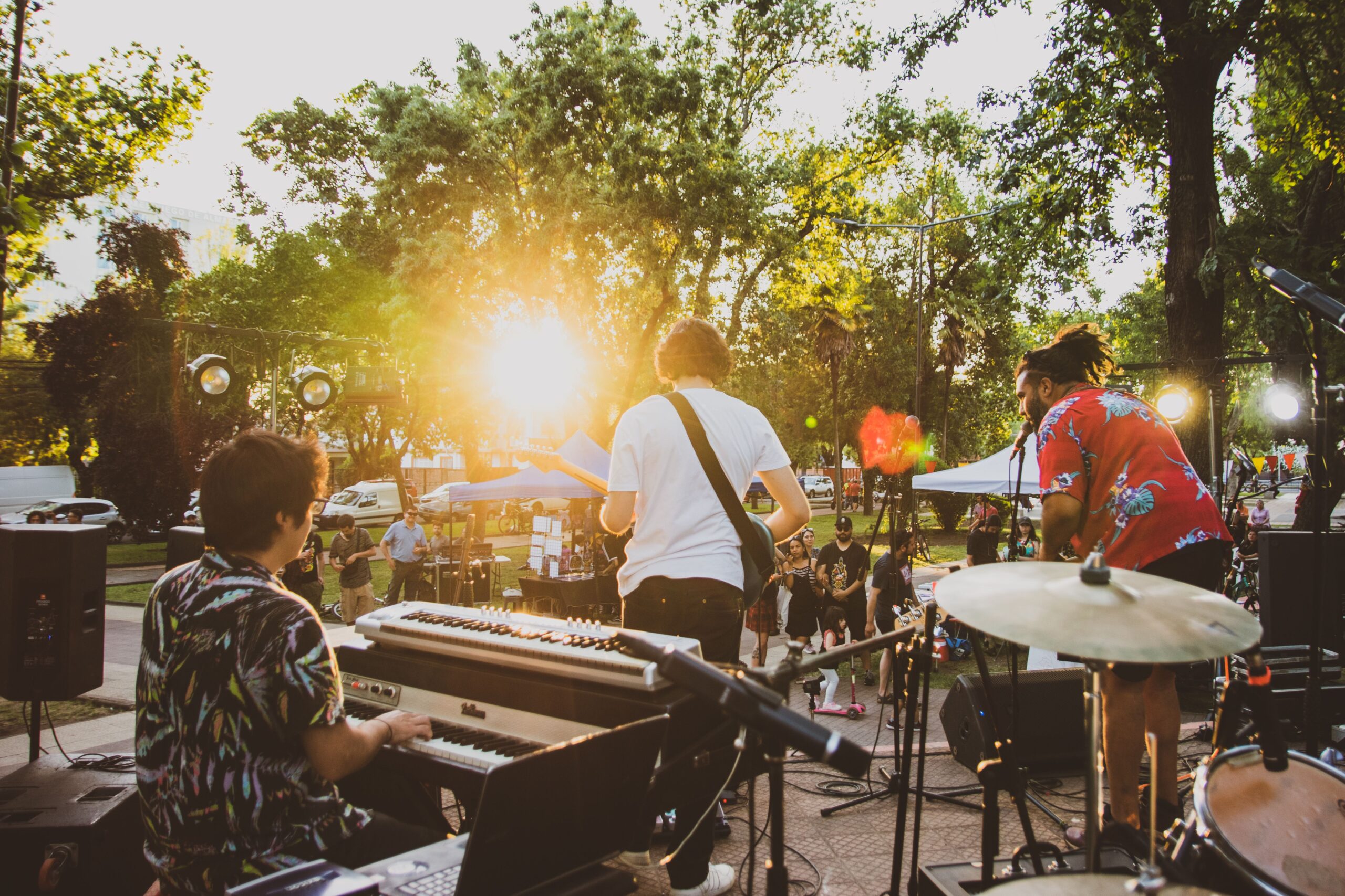 Local live music band performing on an outdoor stage at sunset during a summer event in Florida.